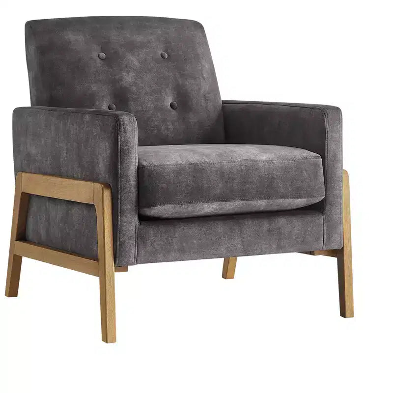 Poltrona moderna ed elegante con schienale trapuntato, rivestita in tessuto e con struttura in legno massello, ideale per il relax e la lettura in salotto