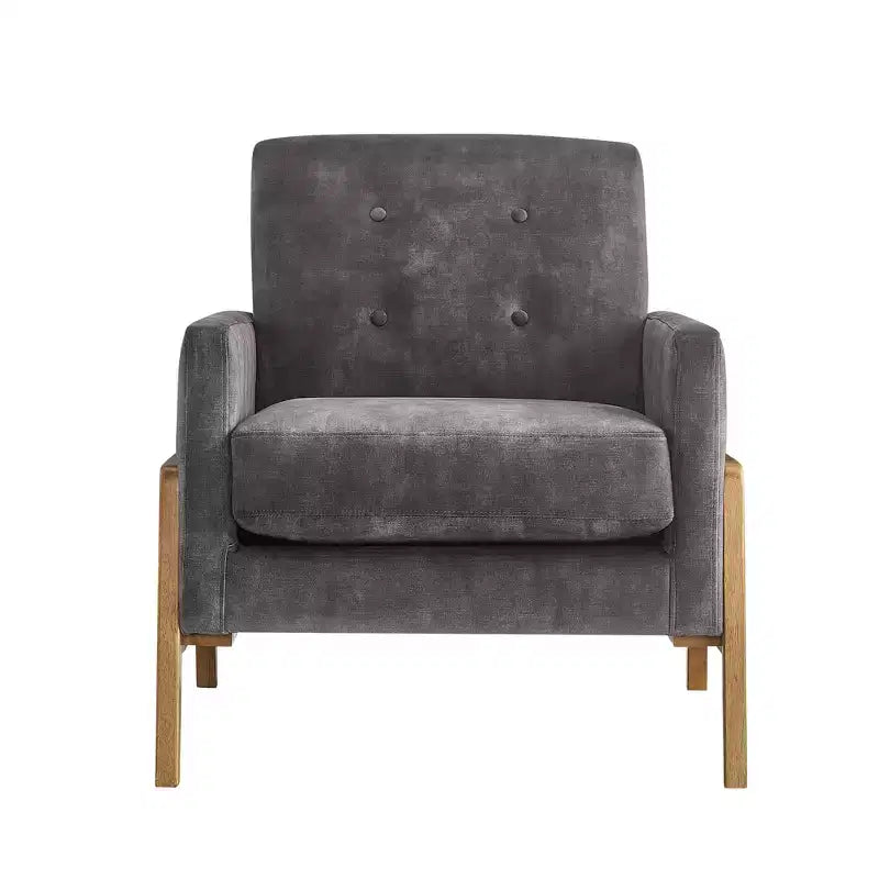 Poltrona moderna ed elegante con schienale trapuntato, rivestita in tessuto e con struttura in legno massello, ideale per il relax e la lettura in salotto